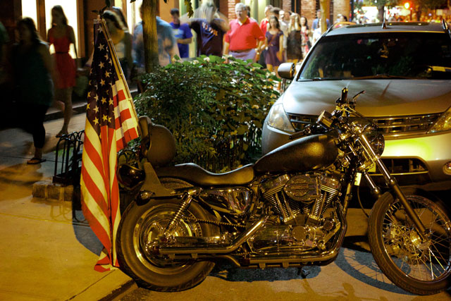 A motorbike flying an American flag