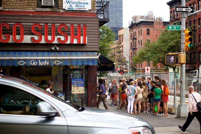 A large crowd outside Go Sushi