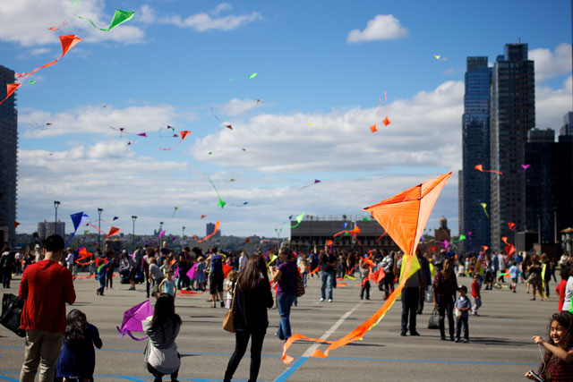 People flying kites above the Port Authority Bus Terminal