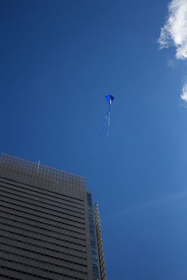 A single kite flying high in the sky