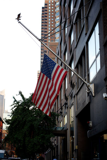 A flag flying at half-mast at a FDNY firehouse