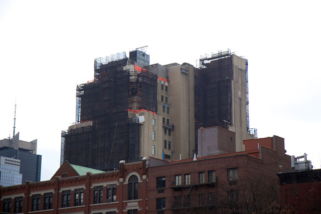 The building from a distance towering over surrounding buildings