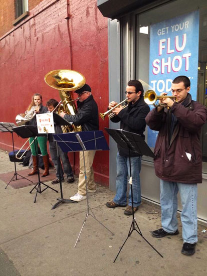 A brass quintet playing on the street