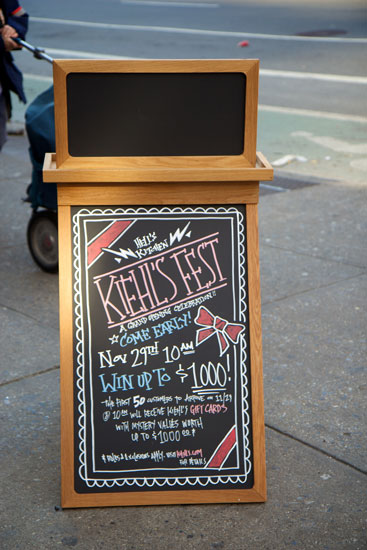 The sidewalk signage announcing the Kiehl's opening promotions