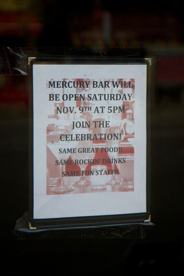 The reopening celebrations flyer on the window of Mercury Bar