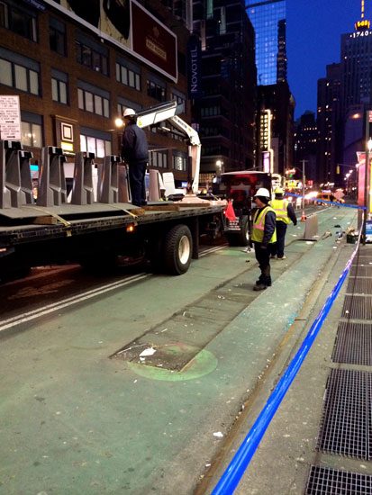 Workers loading Citibike docks onto a truck