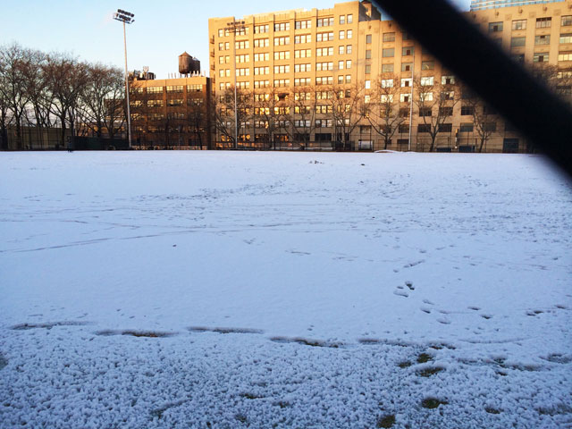 Snow covering the sports field at DeWitt Clinton Park