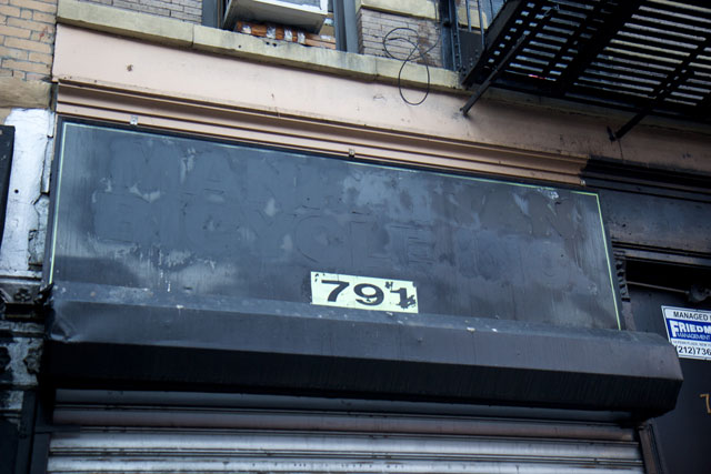 The painted-over signage of Manhattan Bicycles