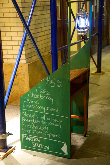 The signage podium listing some of the drinks menu outside Marston Station
