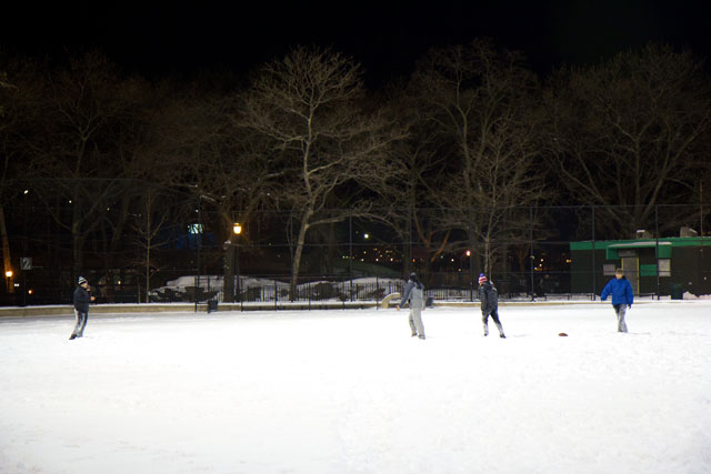 People playing football in the snow