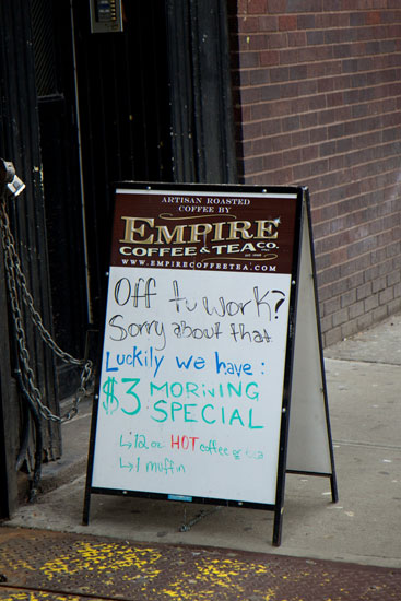 A sandwich board lamenting going back to work