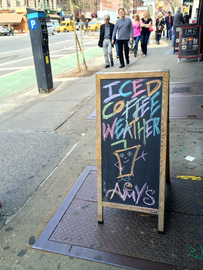 The sandwich board at Amy's Bread saying "Iced Coffee Weather"