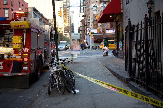 A fire engine next to the debris from the building