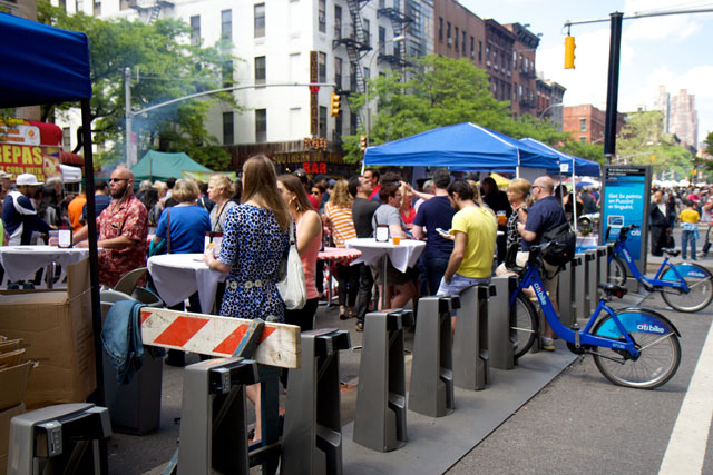 People sitting on the Citibike docks on 9th Ave