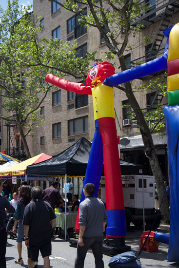 An inflatable waving clown at the food festival