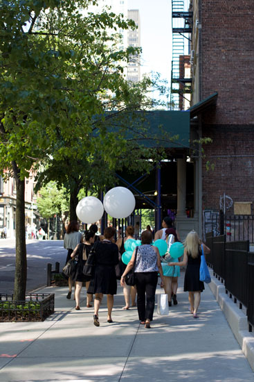 A group carrying several balloons