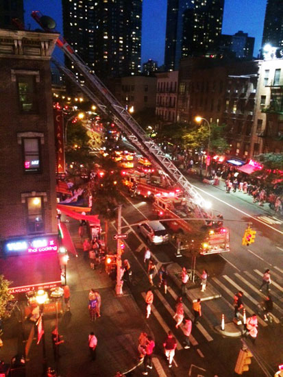 Fire engines and the crowd at the incident on 46th St