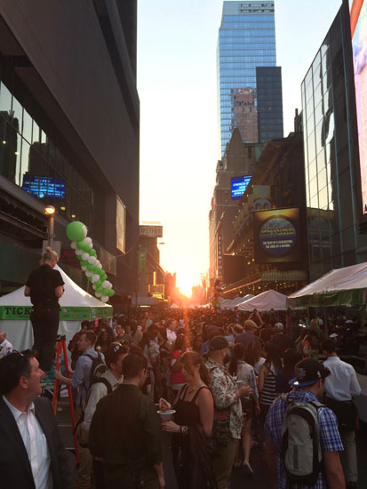 Manhattanhenge over the top of the Taste of Times Square festival
