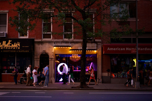 The storefront and glowing "9" sign of @Nine