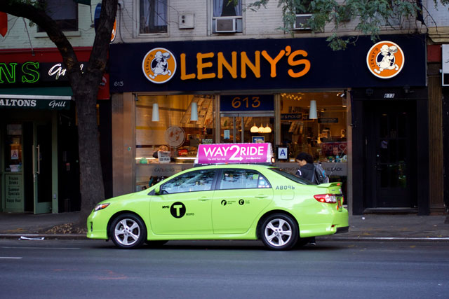 A new green taxi parked on 9th Ave