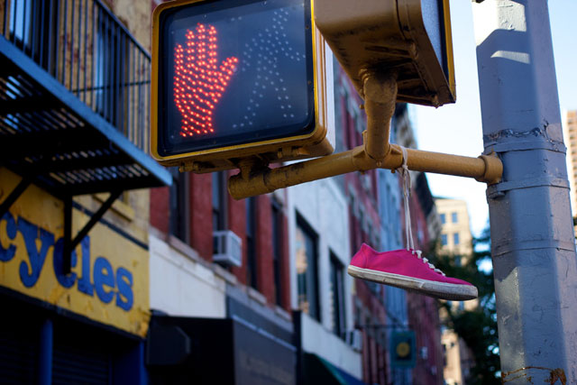 A shoe hanging from traffic lights