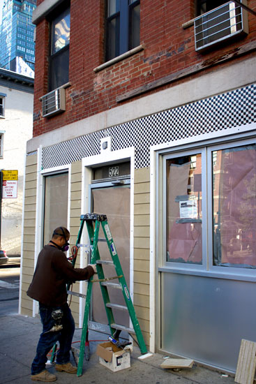 A builder removing tiles from the incoming Snack Taverna