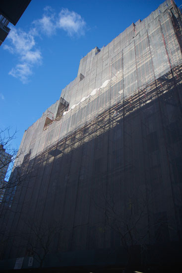 The building and its scaffolding from street-level